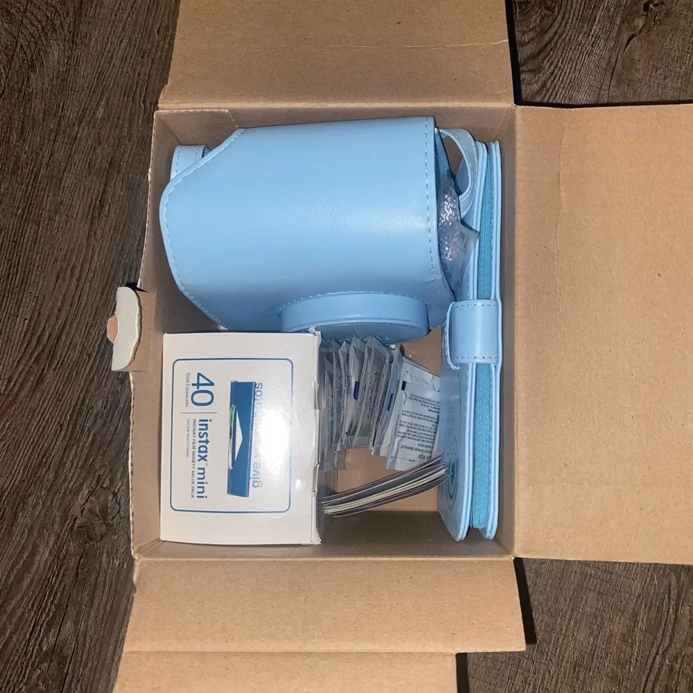 Baby Blue Polaroid Camera with photo book, film, and etc.